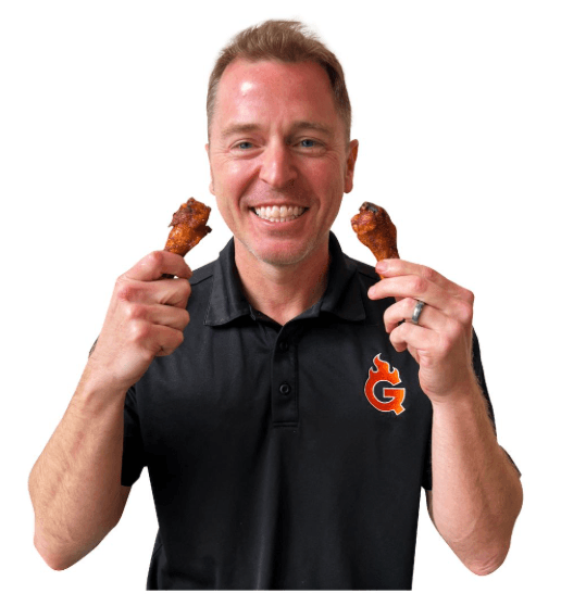 guy holding two chicken wings