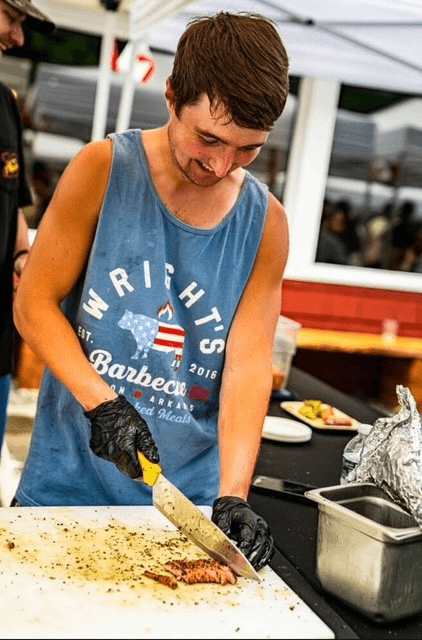 Blake cutting a piece of meat with a sharp knife
