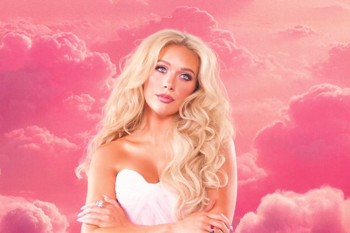 photo of megan moroney in front of pink clouds