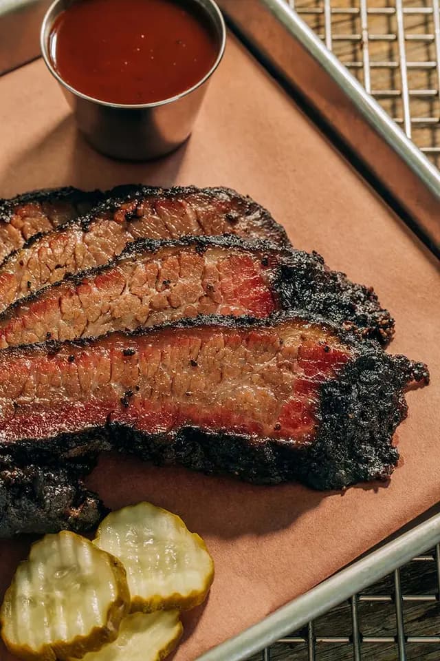 shaved pork sandwich with friend onion rings